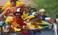 BC Little Leaguers squirting sidewalkcrowd