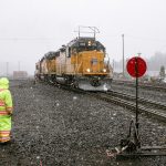 conductor stands by a Union Pacific flanger