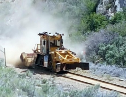 The dustiest job on the railroad is running the ballast regulator. Here it is sweeping the tracks and profiling the roadbed.