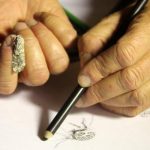 Talented hands drawing a moth