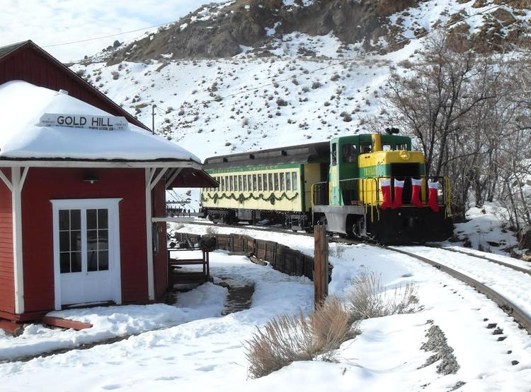 The Virginia and Truckee Railroad's Candy Cane Express Train passing by the historic Gold Hill depot.